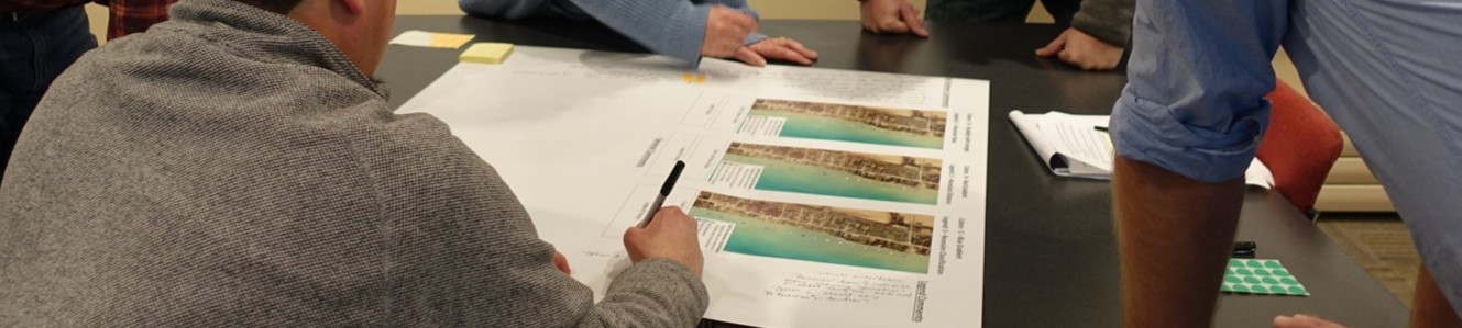 People making notes on a map on a table